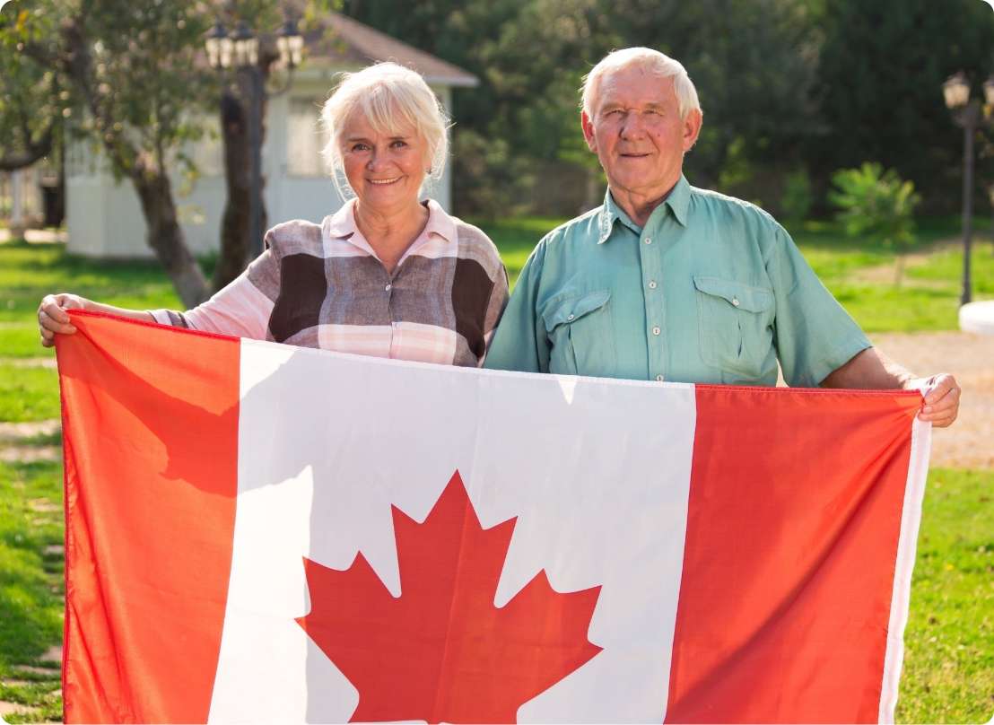 A Canadian couple holding a flag